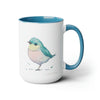 15 oz Two-Toned Mug with Light Blue  Interior and Handle, Glossy Finish, Colorful Light Aqua Blue, Light Yellow, and Light Pink Pastel Standing Bird Design in Watercolor Style. Right View with a Small Brand Name at the Bottom Left Side of the Mug