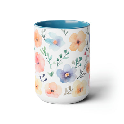 15 oz Two-Toned Mug with Light Blue nterior and Handle, Glossy Finish. Pastel Watercolor Style Floral Print in Light Violet, Light Oranges, and Pinks with Green Leaves on a White Background. Front  View