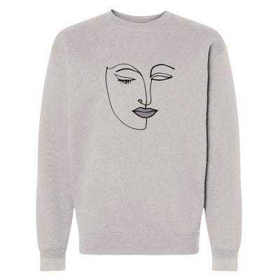 Beauty in Abstract Sweatshirt 10 oz ring spun cotton /polyester blend sweatshirt in bone with embroidered line art of a face of a girl with pink lips front view.