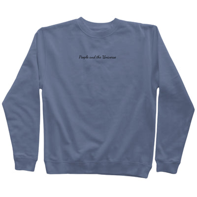 9oz (300 gm) 80% cotton/20% polyester blend pigment dye sweatshirt in slate blue with a black embroidery of brand name at the center horizontally